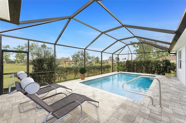 pool featuring glass enclosure and a patio