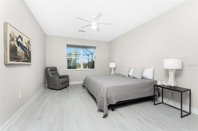 bedroom with baseboards, ceiling fan, visible vents, and wood tiled floor