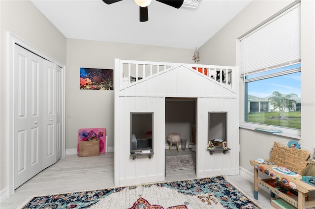 bedroom with ceiling fan, a closet, wood tiled floor, and baseboards