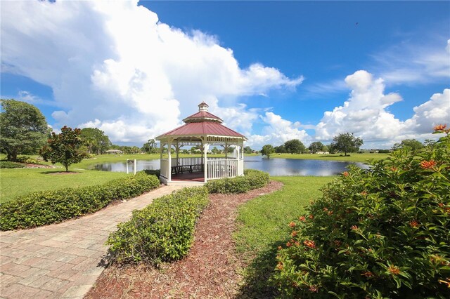 exterior space featuring a water view, a lawn, and a gazebo