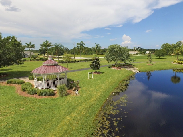 view of community featuring a water view, a yard, and a gazebo