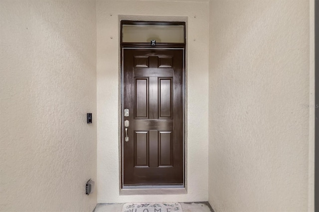 property entrance with stucco siding