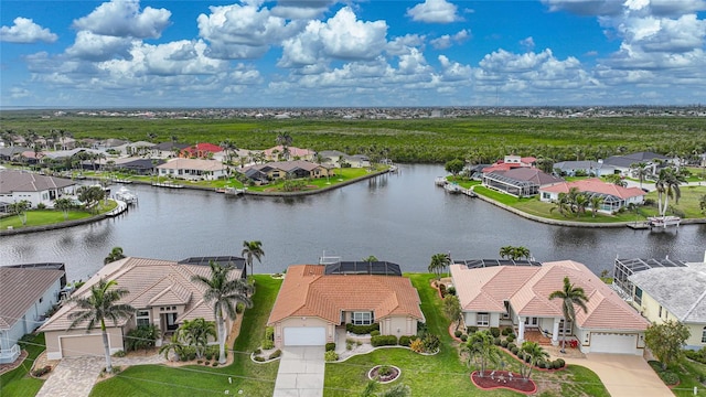 drone / aerial view with a residential view and a water view