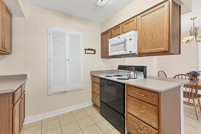 kitchen featuring electric range, light countertops, white microwave, and light tile patterned floors