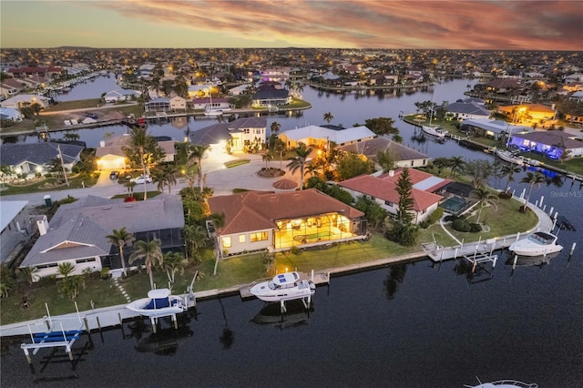 drone / aerial view with a residential view and a water view