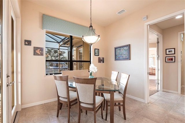 dining room with light tile patterned floors, visible vents, and baseboards