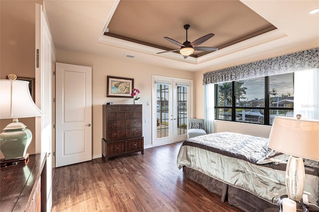 bedroom featuring baseboards, french doors, wood finished floors, a raised ceiling, and access to outside