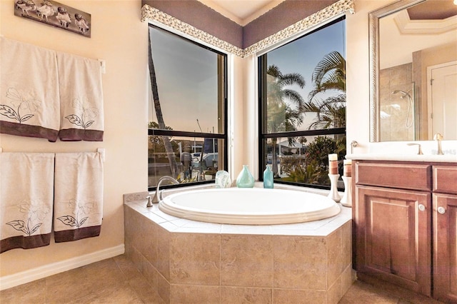 full bath featuring a garden tub, walk in shower, vanity, and tile patterned flooring