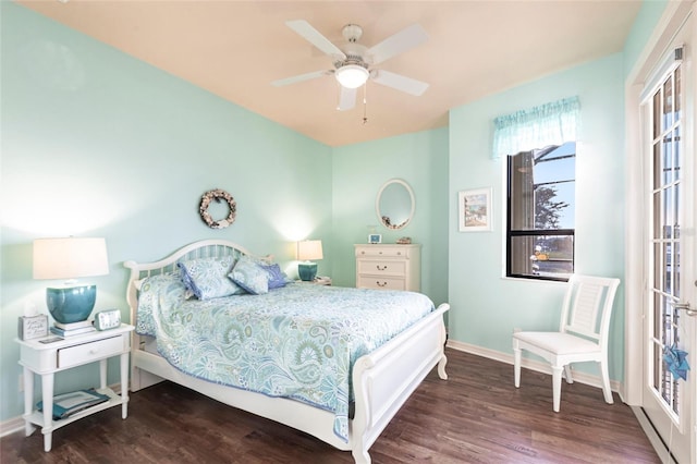 bedroom featuring ceiling fan, baseboards, and wood finished floors