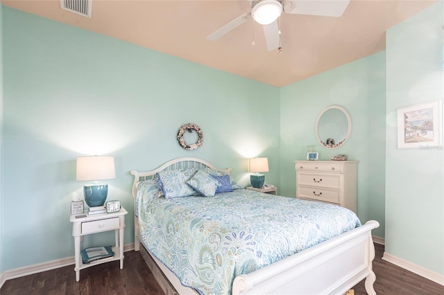 bedroom with visible vents, a ceiling fan, baseboards, and wood finished floors