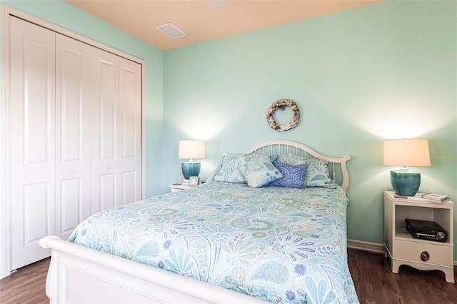 bedroom featuring a closet, visible vents, and wood finished floors