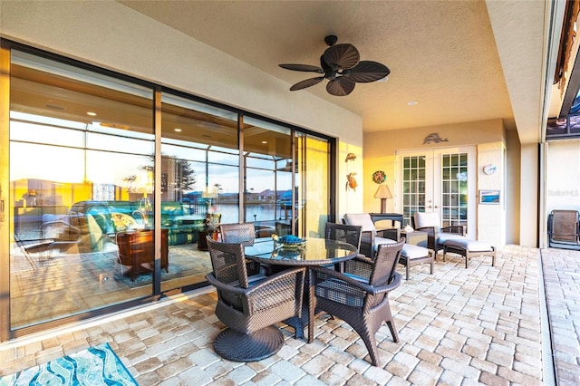 view of patio with french doors, outdoor dining space, and a ceiling fan