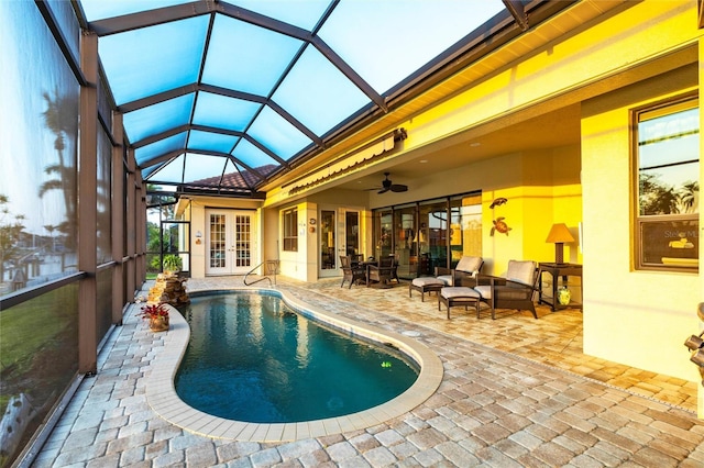 pool featuring a patio, an outdoor living space, ceiling fan, french doors, and a lanai