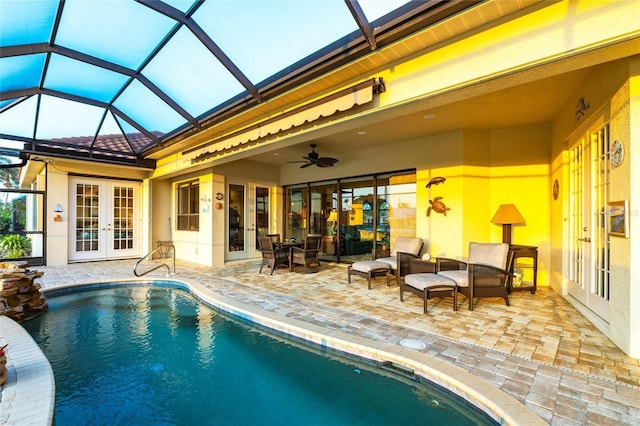 outdoor pool with an outdoor living space, a patio, french doors, glass enclosure, and ceiling fan