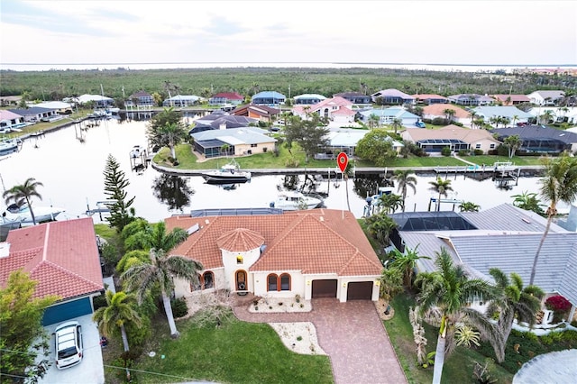 drone / aerial view with a residential view and a water view