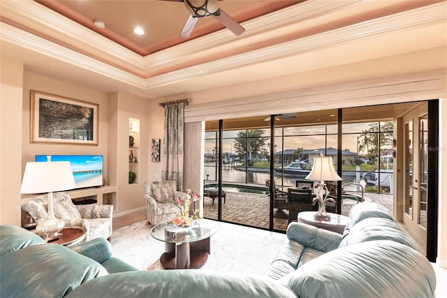 living room featuring recessed lighting, a tray ceiling, crown molding, and a ceiling fan