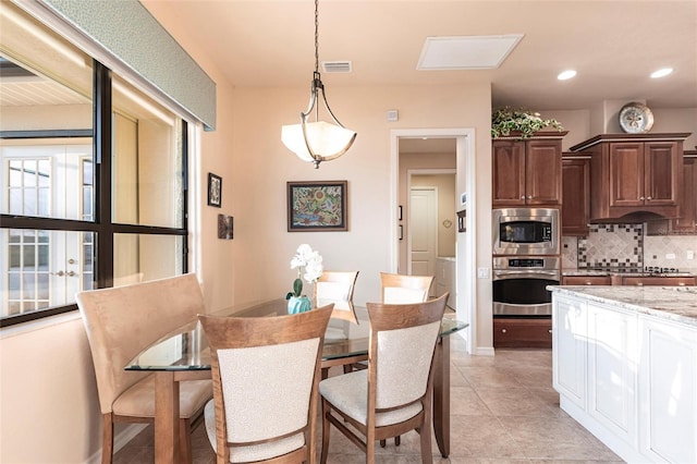 dining space with light tile patterned floors, recessed lighting, visible vents, and baseboards