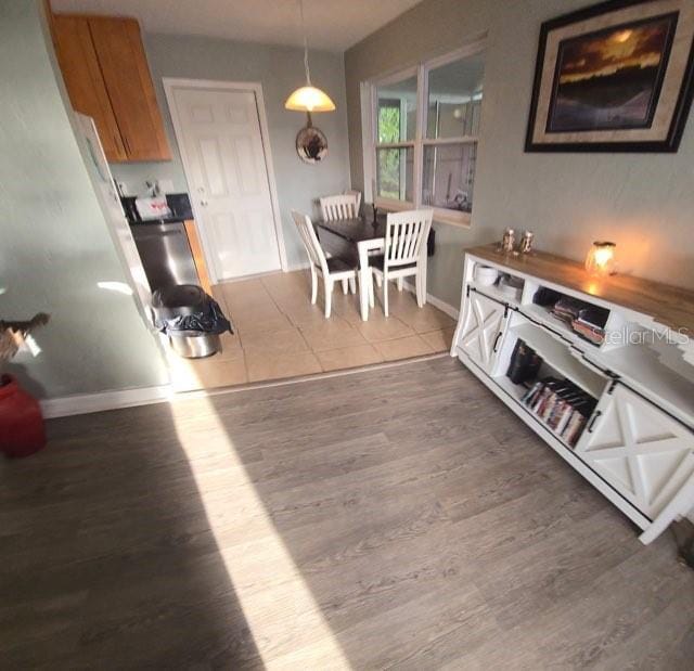 dining room with baseboards and wood finished floors