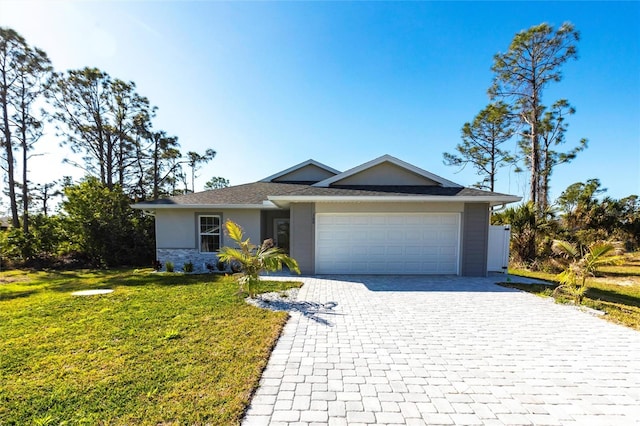 view of front of property with a front lawn, decorative driveway, an attached garage, and stucco siding