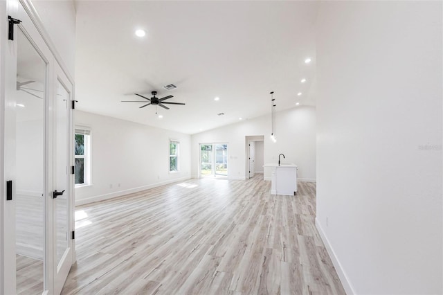 unfurnished living room featuring recessed lighting, visible vents, baseboards, vaulted ceiling, and light wood-style floors