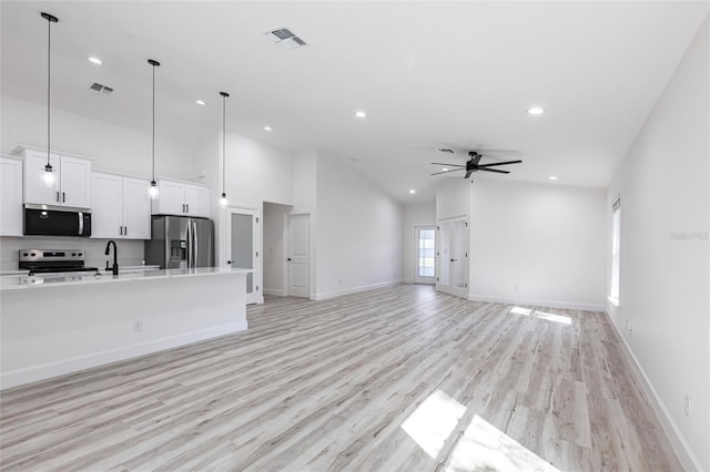 unfurnished living room featuring light wood-style flooring, visible vents, a ceiling fan, and recessed lighting