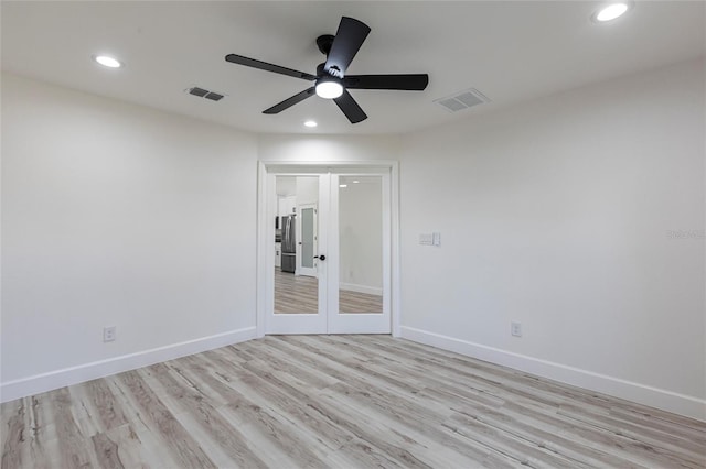 spare room with baseboards, recessed lighting, visible vents, and light wood-style floors