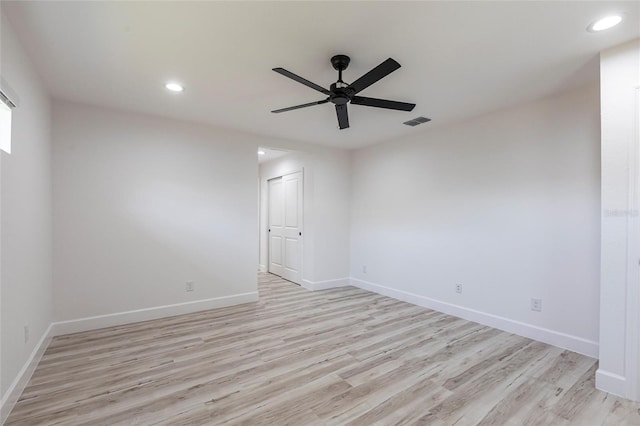 empty room with light wood-style flooring, visible vents, baseboards, and recessed lighting