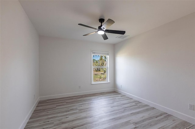 empty room with light wood-type flooring, baseboards, visible vents, and ceiling fan