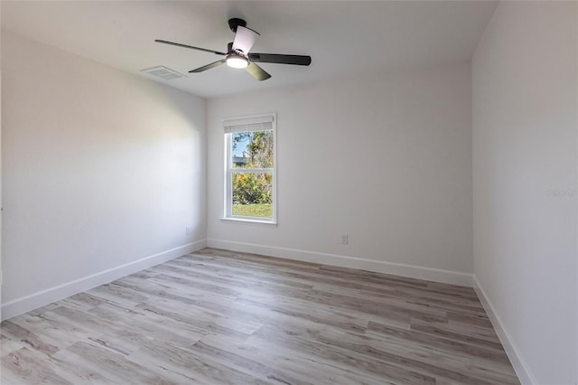 unfurnished room featuring light wood-style floors, baseboards, visible vents, and a ceiling fan