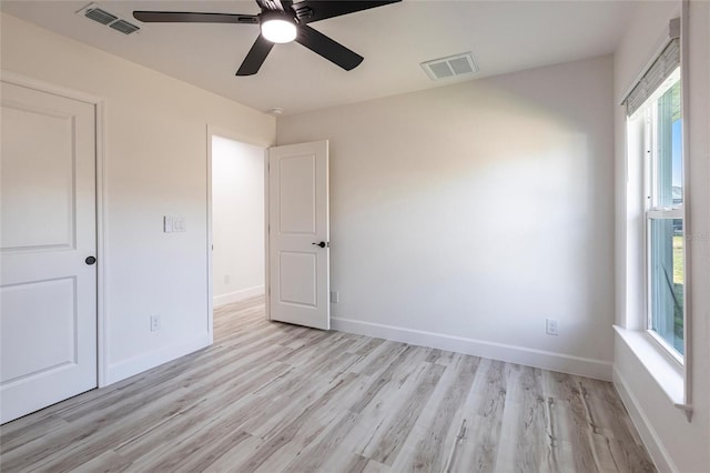 unfurnished bedroom featuring baseboards, visible vents, and light wood-style flooring