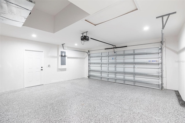 garage with recessed lighting, electric panel, and a garage door opener