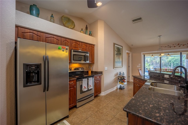 kitchen featuring visible vents, vaulted ceiling, stainless steel appliances, a sink, and light tile patterned flooring