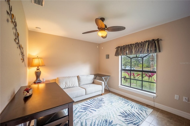 tiled living room with a ceiling fan, visible vents, and baseboards