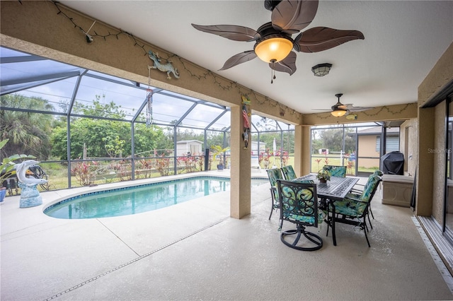 outdoor pool featuring ceiling fan, a patio, and a lanai