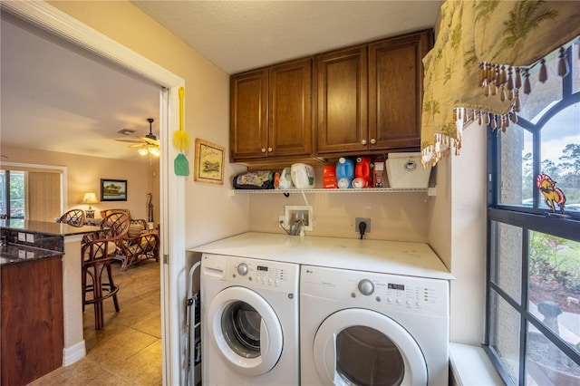 clothes washing area featuring cabinet space, light tile patterned floors, a ceiling fan, and independent washer and dryer