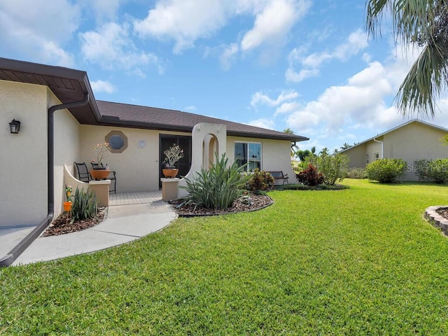 view of front of property with a front lawn and stucco siding