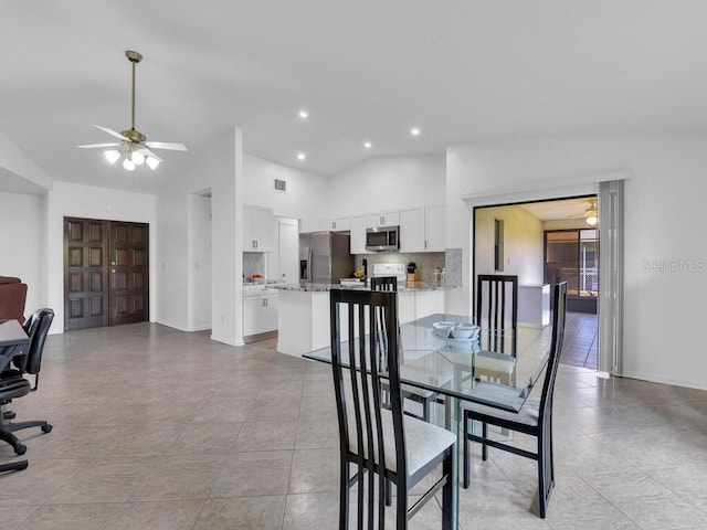 dining room with ceiling fan, high vaulted ceiling, visible vents, and baseboards