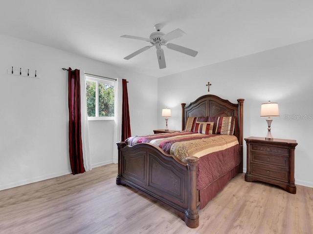 bedroom with baseboards, ceiling fan, and light wood finished floors