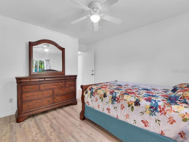 bedroom featuring light wood-style flooring and a ceiling fan