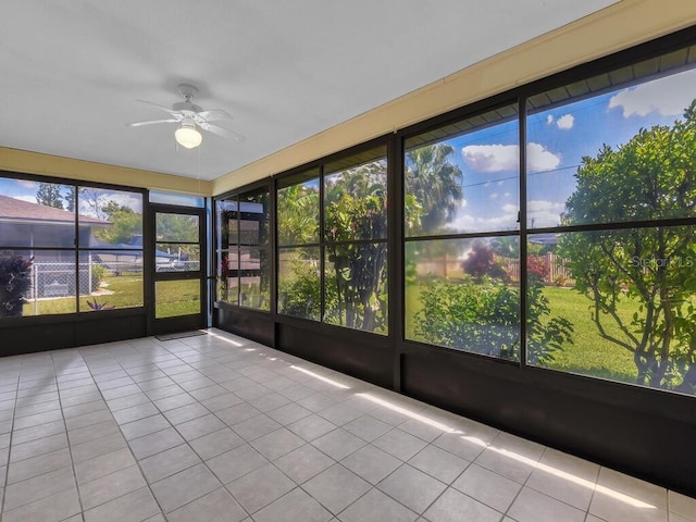 unfurnished sunroom with a ceiling fan