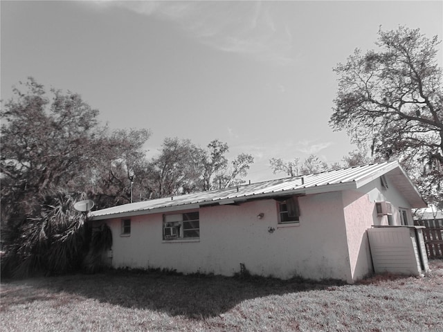 view of home's exterior with metal roof and stucco siding