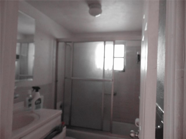 bathroom featuring a shower with door