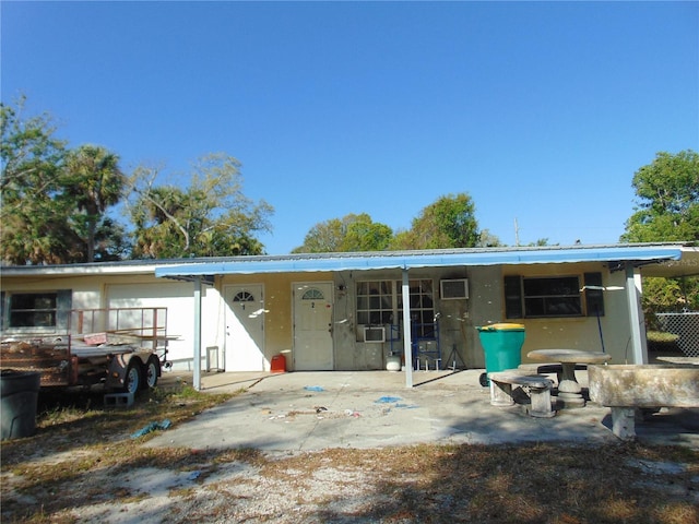 rear view of house featuring metal roof and a patio area