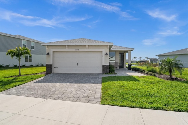 view of front of home featuring a front lawn, decorative driveway, an attached garage, and stucco siding