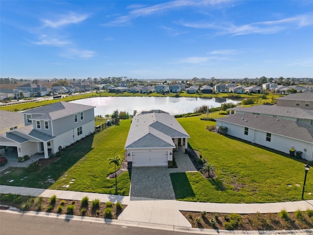 birds eye view of property with a water view and a residential view