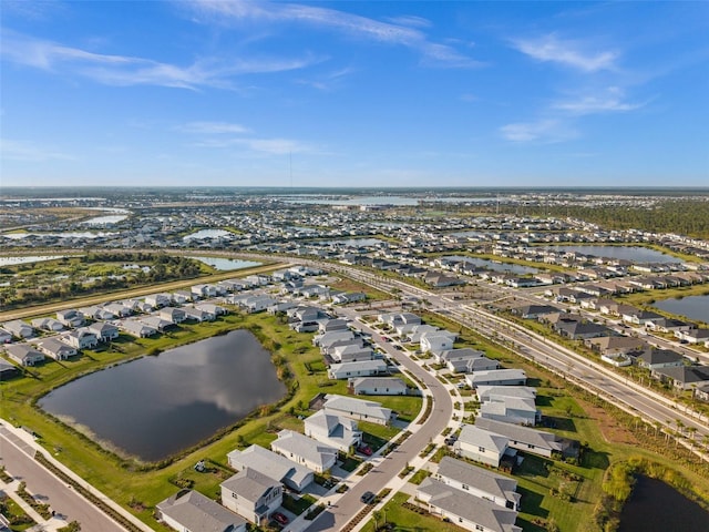 drone / aerial view featuring a water view and a residential view