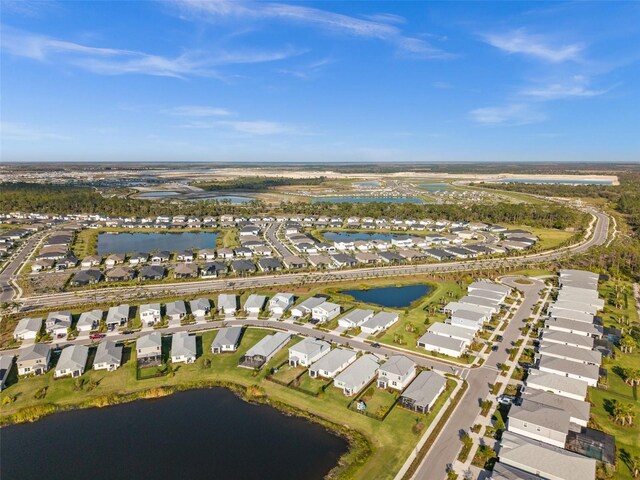 birds eye view of property with a residential view and a water view