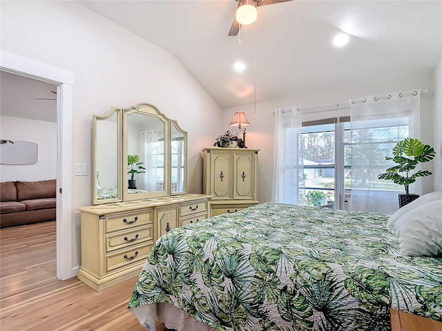 bedroom featuring light wood-type flooring, lofted ceiling, and ceiling fan