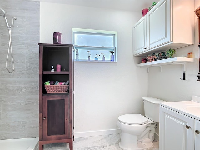 bathroom featuring toilet, vanity, baseboards, marble finish floor, and tiled shower