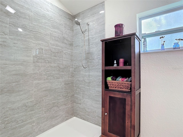 bathroom with tiled shower